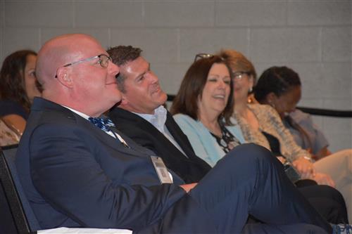 Principal Brian Clayton and other district employees watching from seats